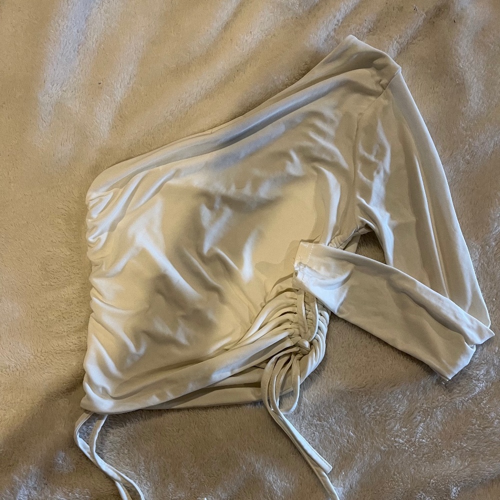 One sleeve white Nasty Gal crop top.